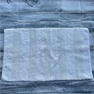 DKNY white bathroom rug 33in x 19in EUC